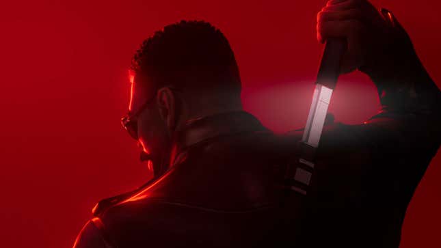 An image shows Blade with a sword in front of a red background.