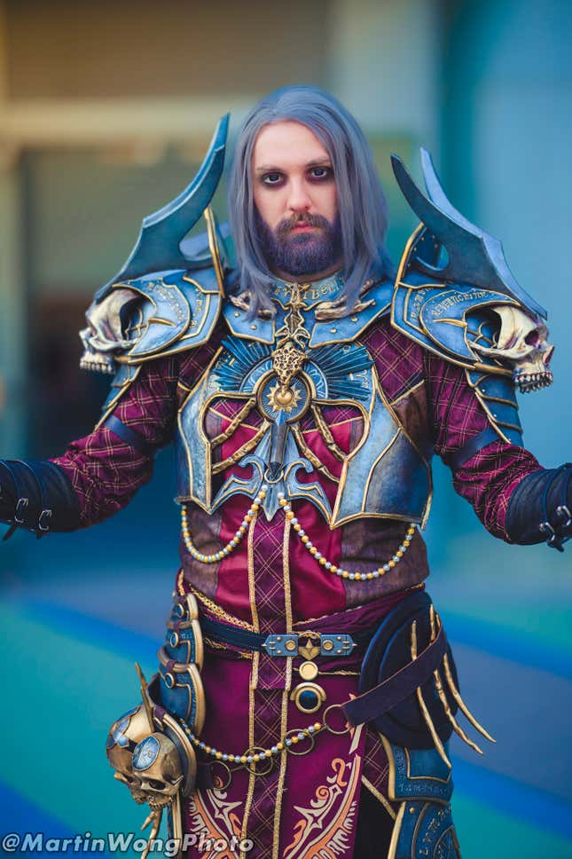 A cosplayer dressed as a Diablo IV Necromancer spreads his arms. 